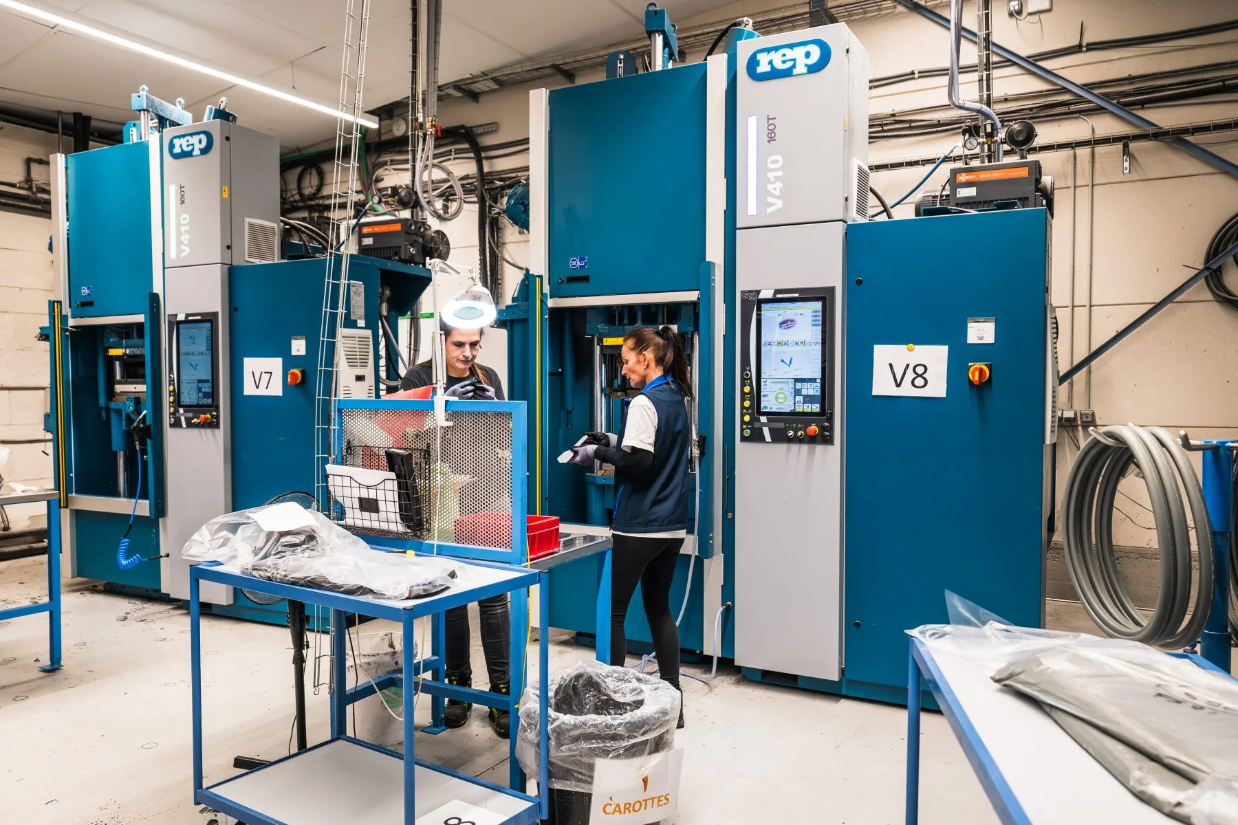 Apt moulding shop · two REP V410 presses (V7 and V8) with operators mid-cycle