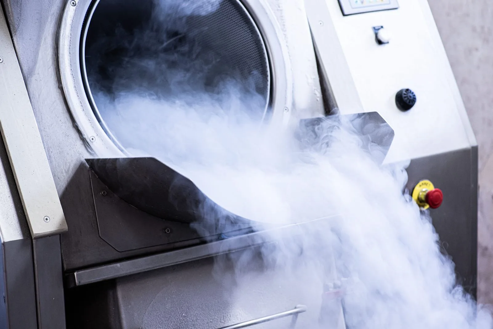 Stainless steel post-cure oven with steam escaping from the sealed tank.