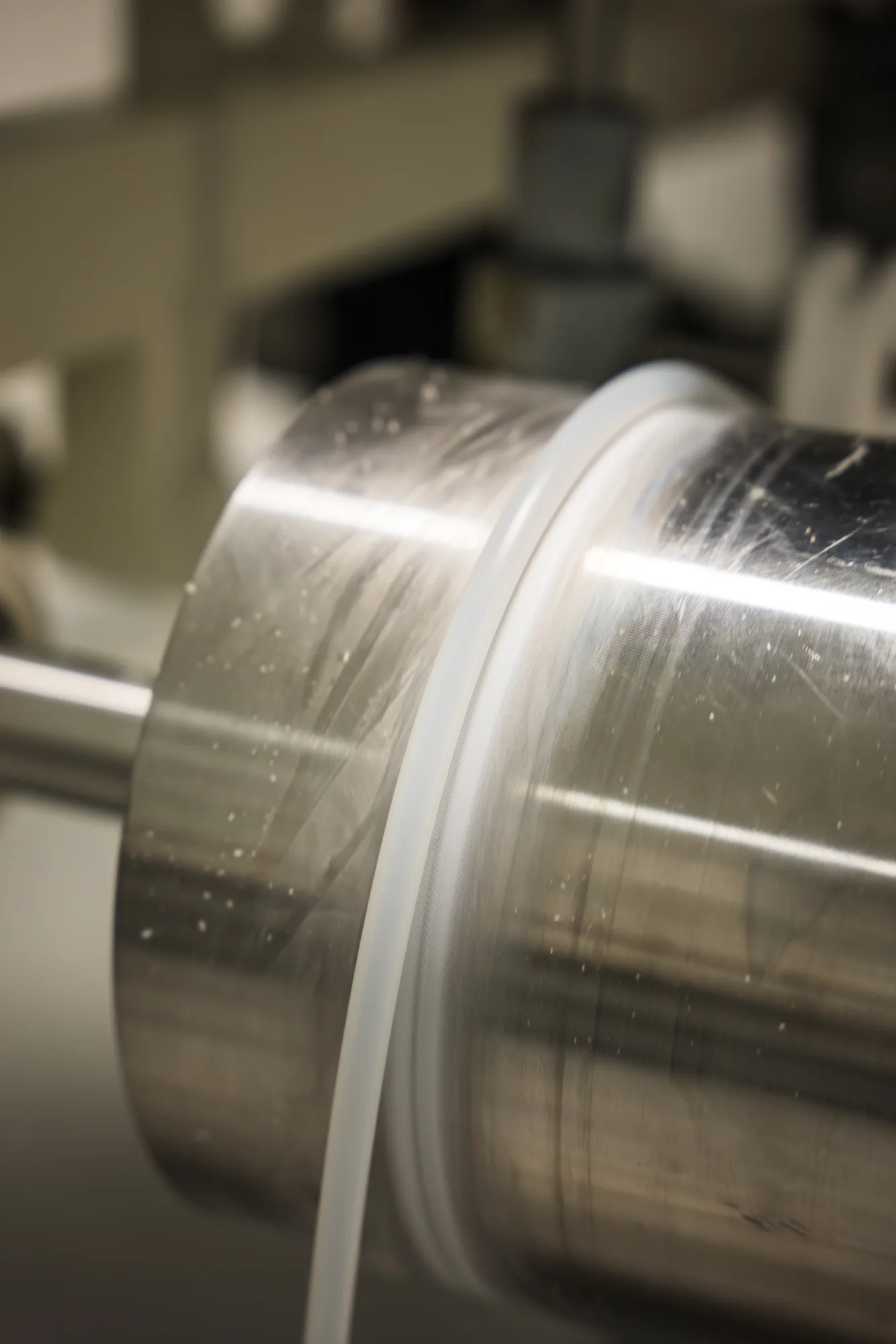 Translucent medical tube being wound at the exit of the extrusion line.